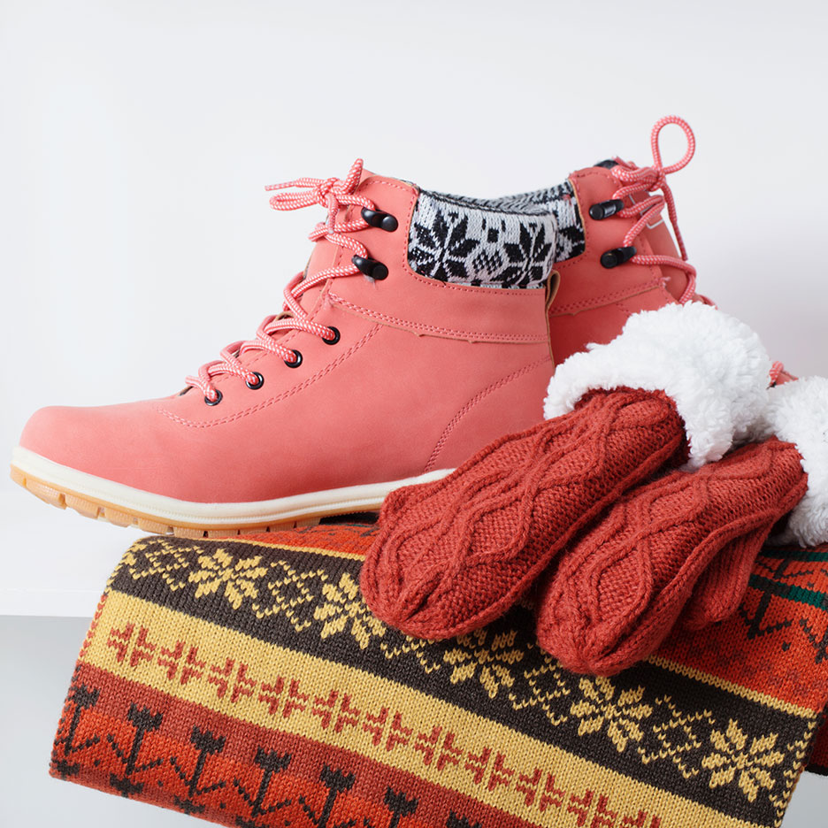 Pink winter boots, red mittens, and a patterned scarf.