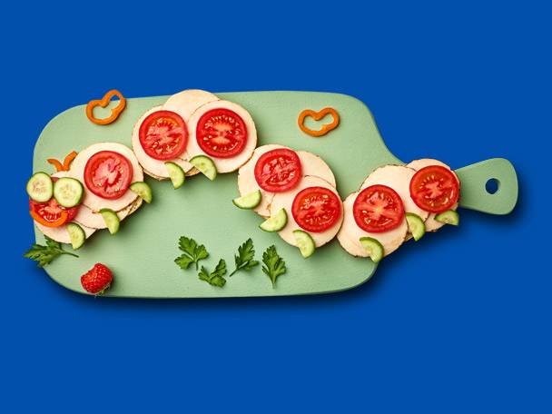 Tomato and cucumber sandwiches shaped like a caterpillar.