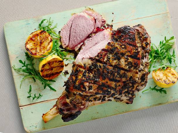 Roasted leg of lamb and grilled lemons.