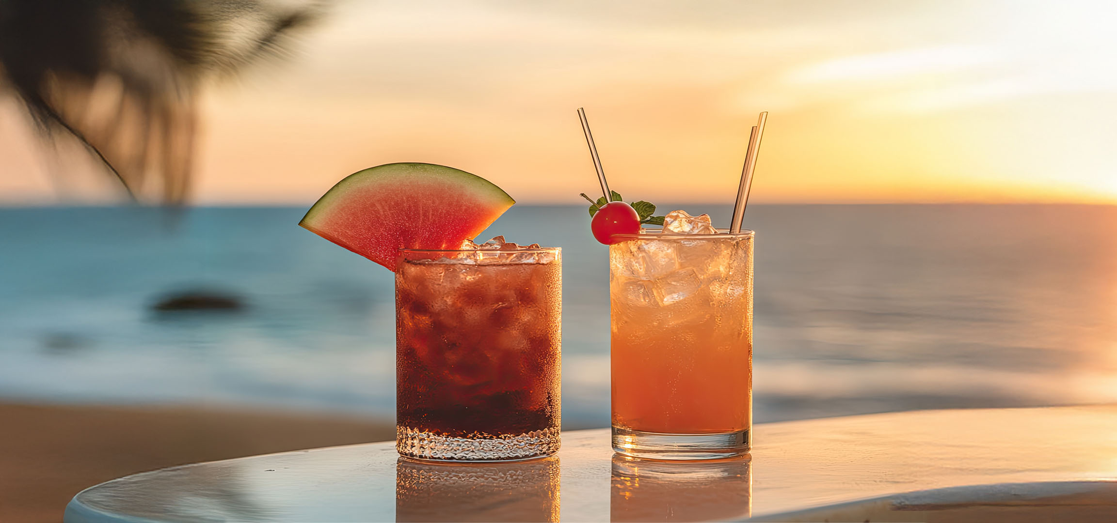 Two cocktails at sunset on the beach.