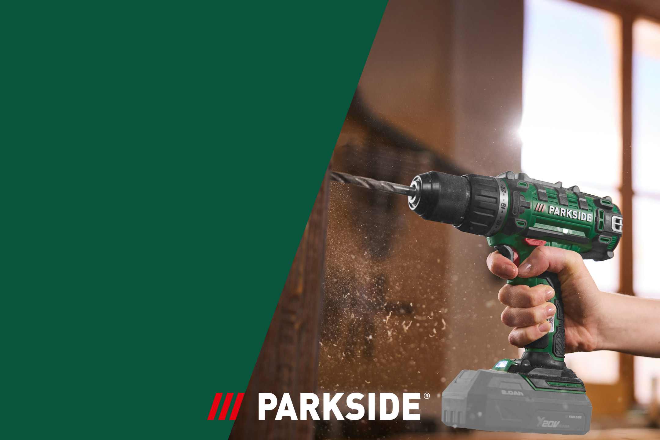 Cordless drill in use, drilling into wood, with wood dust flying around.