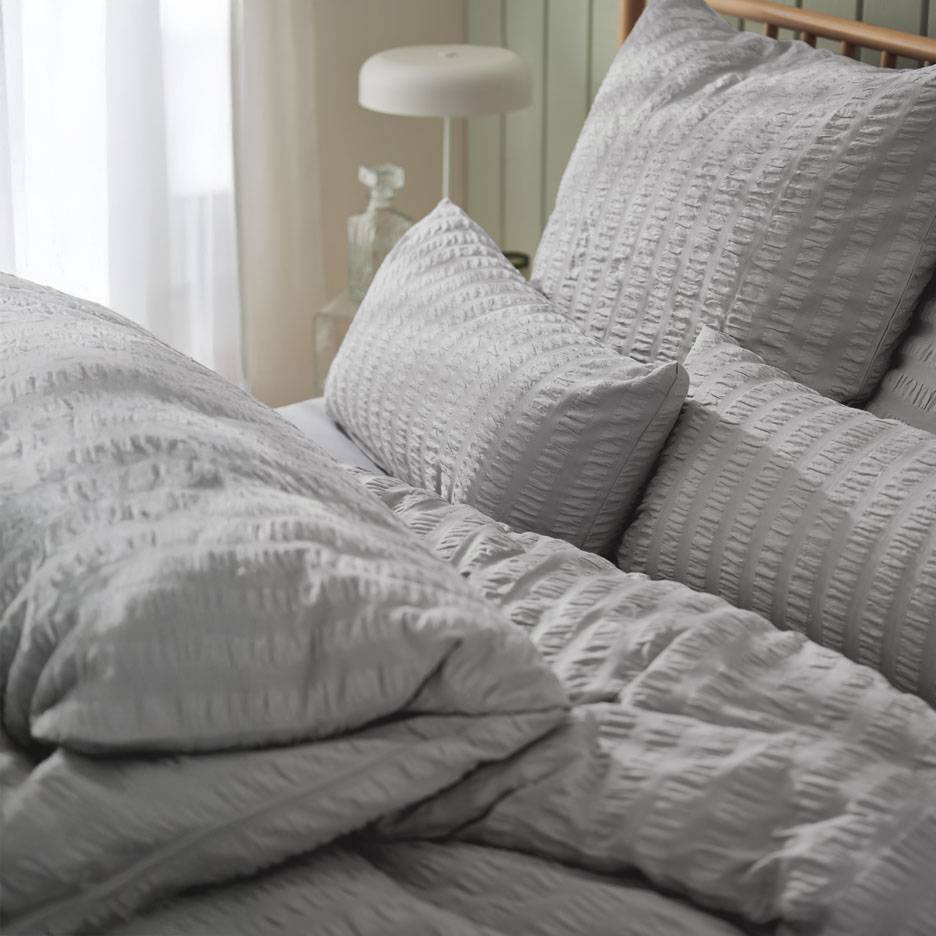 Grey bedding set with textured pillows.