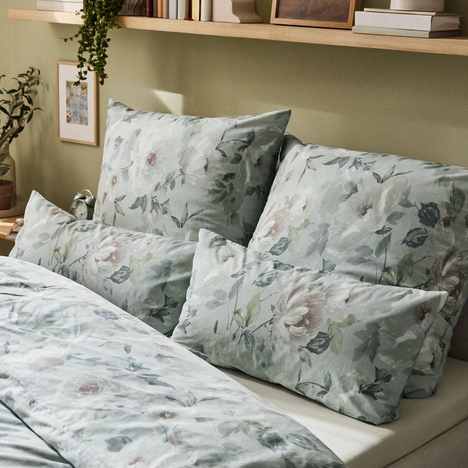 Floral bedding in grey-green tones.