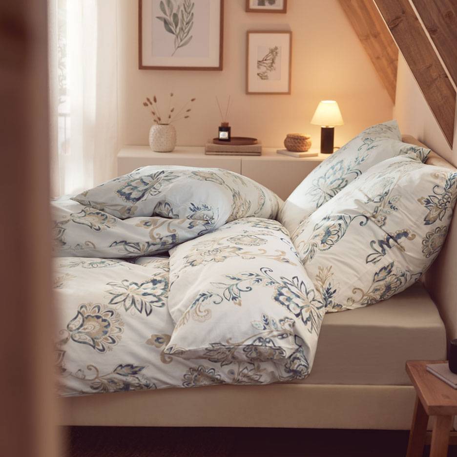Floral bedding on a bed.