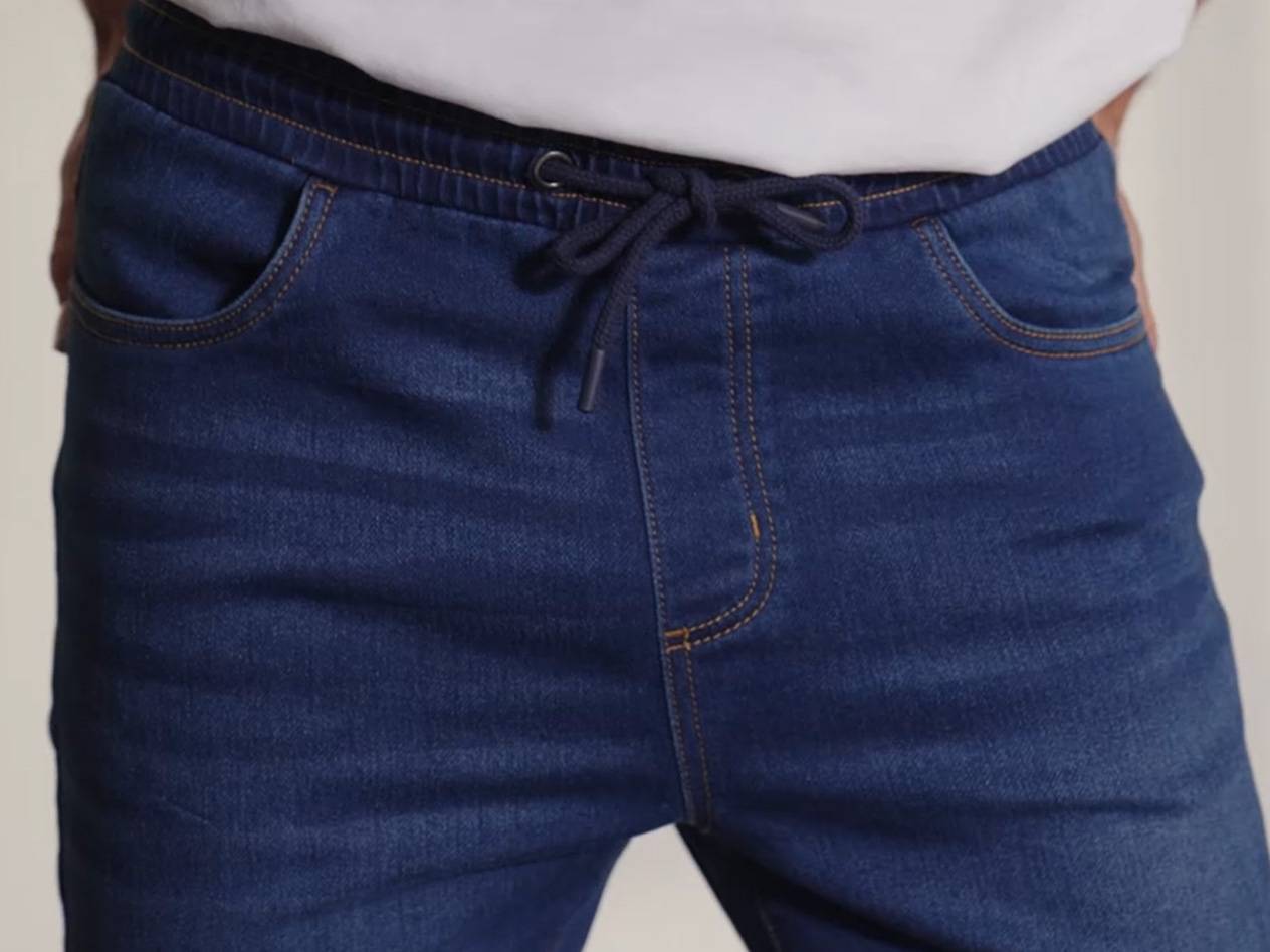 Dark wash jeans with drawstring waist.