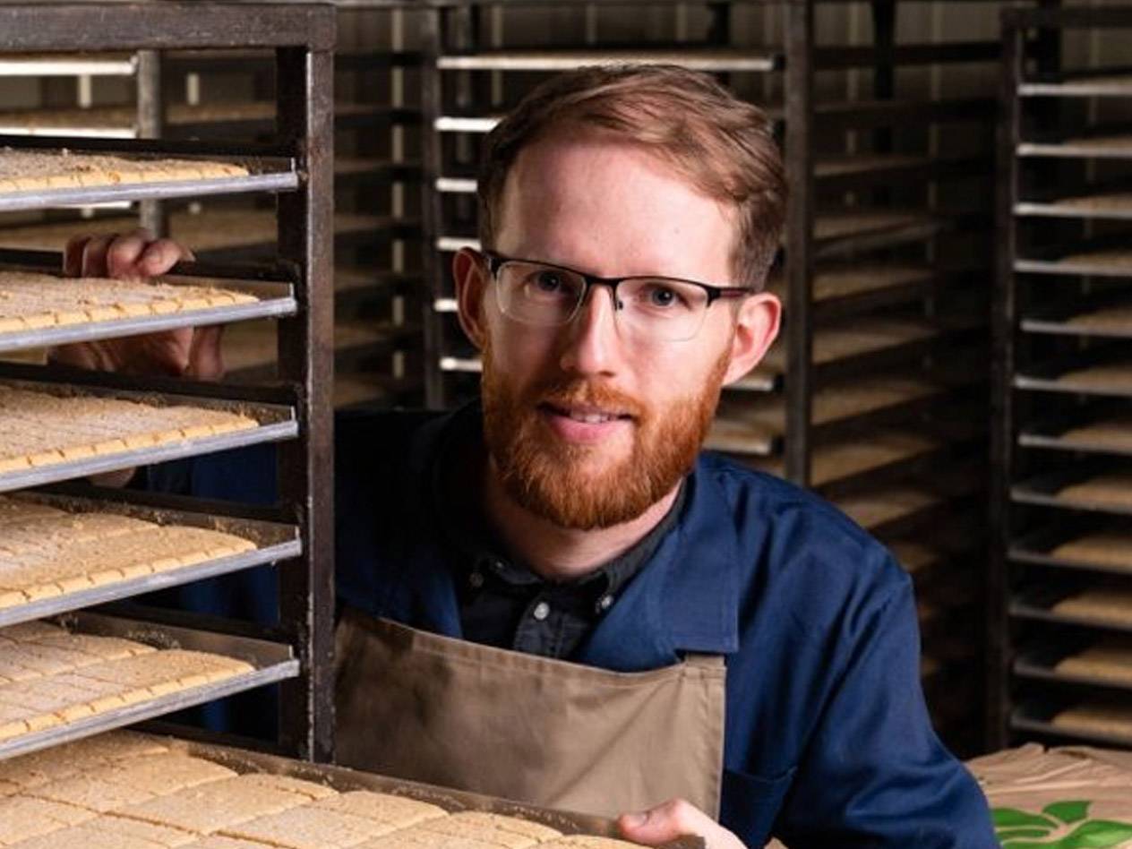 Cookies and a baker in a bakery.