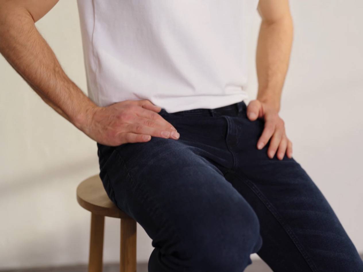 Man in jeans and white shirt.